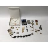 A group of costume jewellery and masonry items to include pins, medals an interesting metal bound