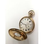 A gold fused half hunter pocket watch with subsidiary dial.