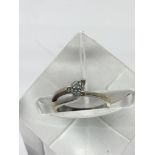 An 18ct gold ring set with a solitaire diamond.Approx size I