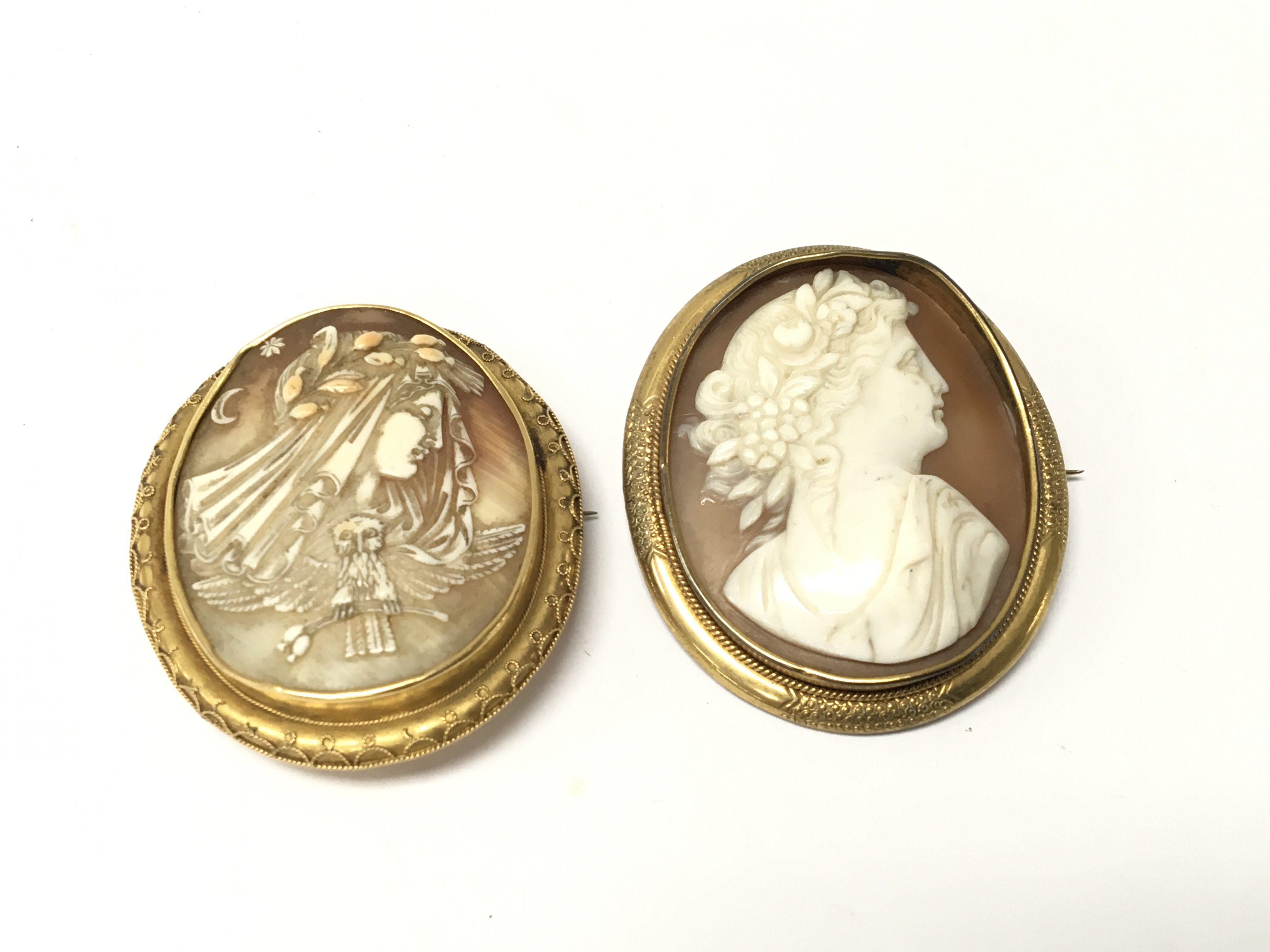 Two cameo brooches carved in the form of side port