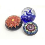 Three glass paperweights, one having a loose Tudor design influence.