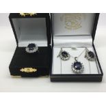 A sapphire and CZ jewellery set comprising a ring, pair of earrings and a necklace.