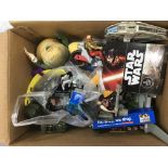 A box of various toys including Lego, Star Wars and other items.