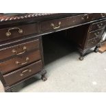 A mahogany pedestal desk fitted with 9 drawers on