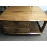 A Ercol low occasion table of square form inset with two drawers