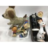 A collection of Disney character figures, a wind up soft dog toy, perfume bottle etc.