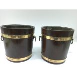 A good pair of wooden and brass mounted ice bucket