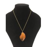 A 9ct gold chain with butterscotch amber pendant
