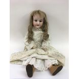 A German Armand Marseille bisque headed doll.Approx 45cm long