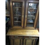 A Victorian walnut bookcase with glazed and solid cupboard doors having two single drawers on bun