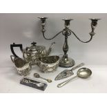 A small collection of silver plated items comprising a three branch candelabra, three piece tea