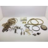 A collection of gold and gold tone jewellery plus some silver items.