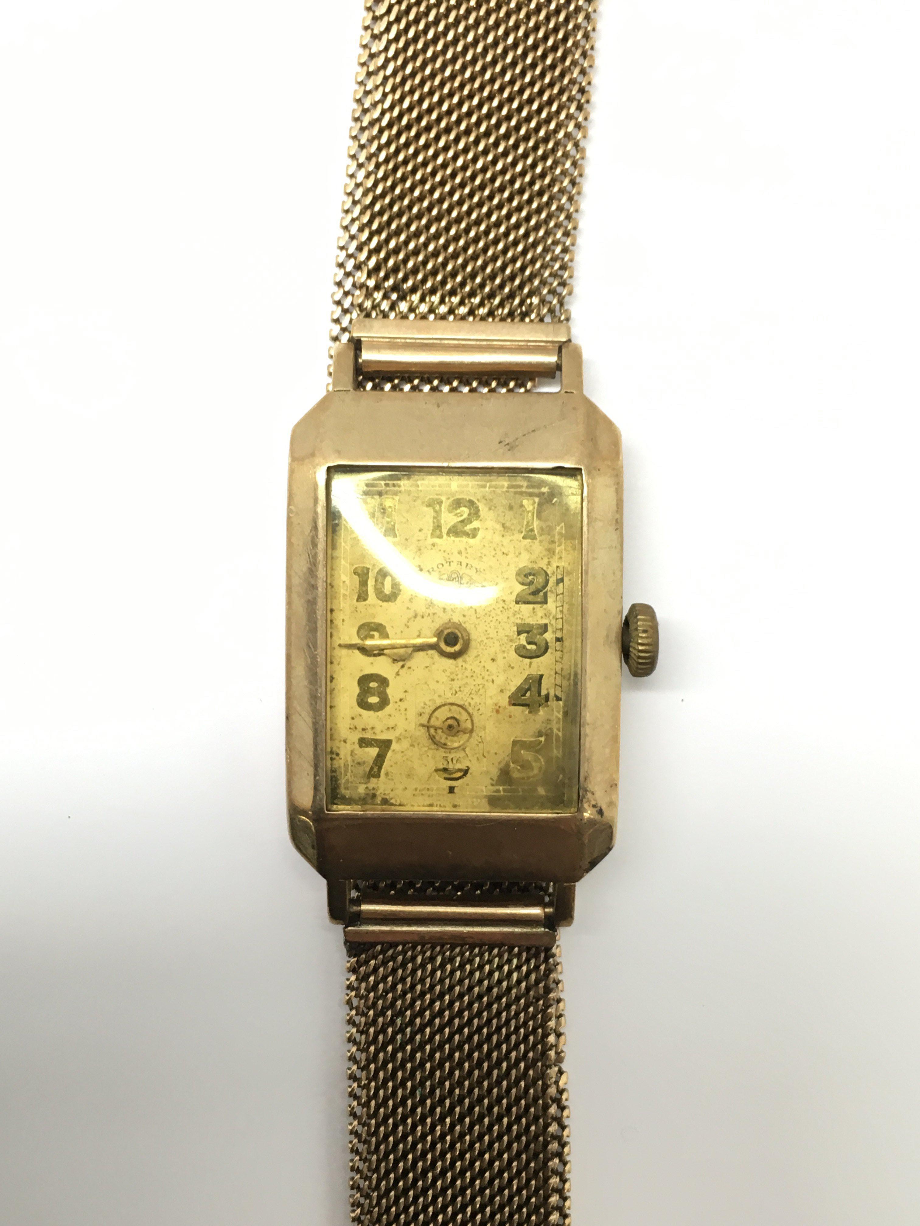 A gents vintage Rotary 9ct gold cased wristwatch, mounted on a 9ct gold Milanese mesh style strap.