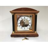 A German mantle clock by maker Hermle, with key. Height approx 34cm.