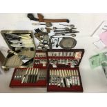 A collection of odds including cased cutlery, some silver and military buttons