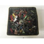 Included is a large tin of ,teal and plastic figures including soldiers, cowboys and animals.