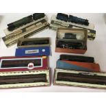 Included are 4 oo gauge locomotives, 2 of which are wren. Also included are 4 coaches.