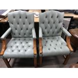 A set of four open arm chairs with green leather button back and seat on square tapering legs and