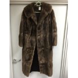 A full length brown fur coat