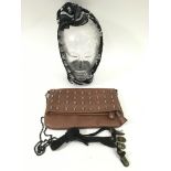 A handbag applied with metal skulls, conforming sc