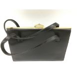 A vintage, black suede leather frame handbag