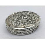 A Continental silver box of oval shape decorated w