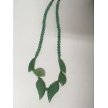 A hard stone green necklace of Art Deco style in a