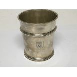 A silver beaker engraved with two coats of arms. W