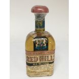 A bottle of Vintage Red Hill High Quality Whisky o