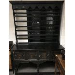 An oak dresser with display shelving to the back.