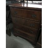 A small flight of drawers fitted with four drawers