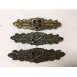 A group of three German WW2 close combat clasps, b