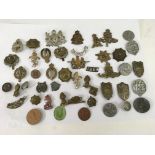 A collection of military cap badges including Germ