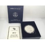 A 2012 Burnished Uncirculated one ounce Silver (9.99%) American Eagle Dollar. Designed by Adolph A