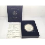 A 2006 Burnished Uncirculated one ounce Silver (9.99%) American Eagle Dollar. Designed by Adolph A