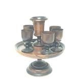 A 19th century treen turned mahogany egg cup stand