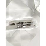A 9ct white gold ring set with small diamond chips