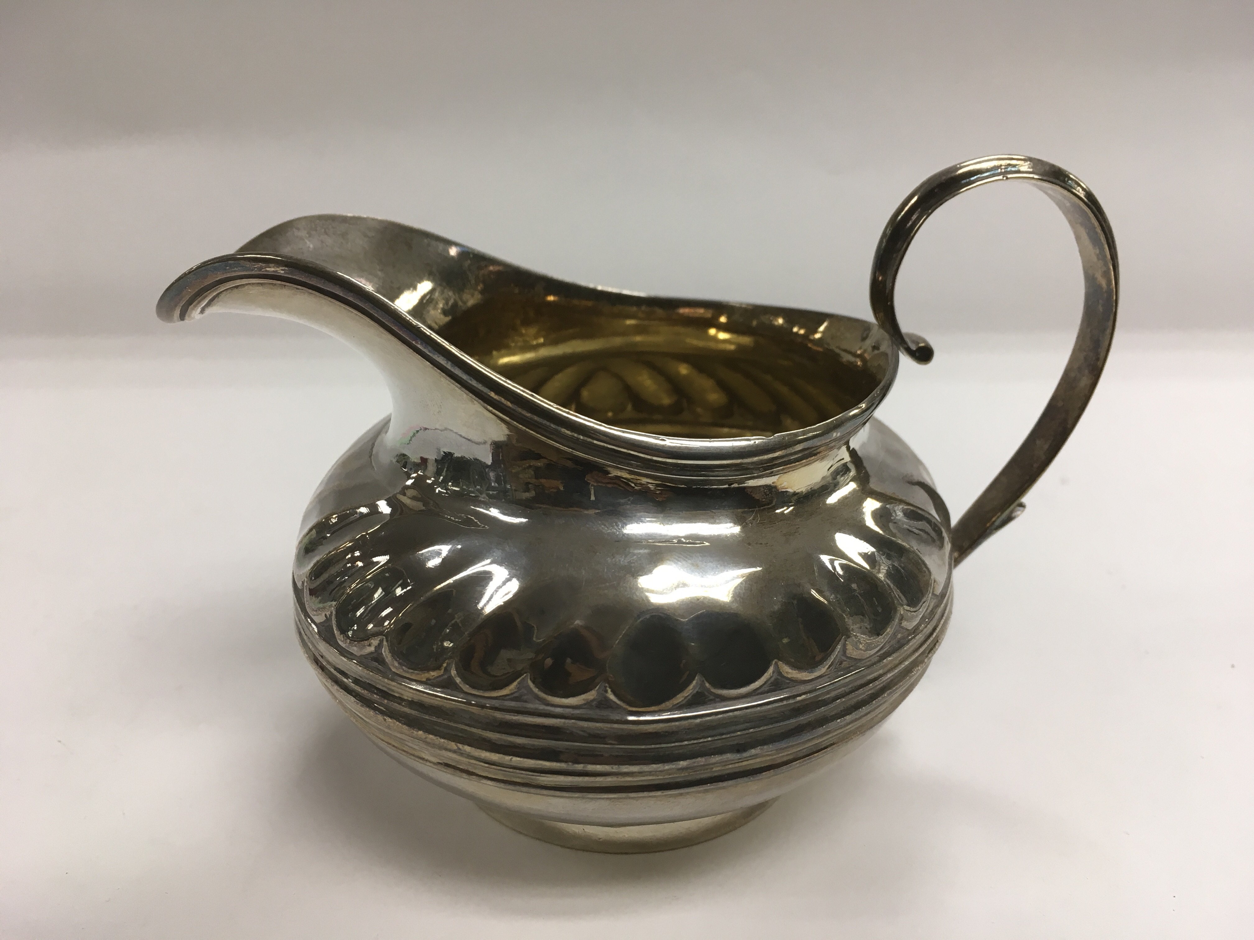 A Victorian silver gilt jug with banded decoration