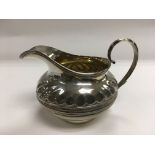 A Victorian silver gilt jug with banded decoration