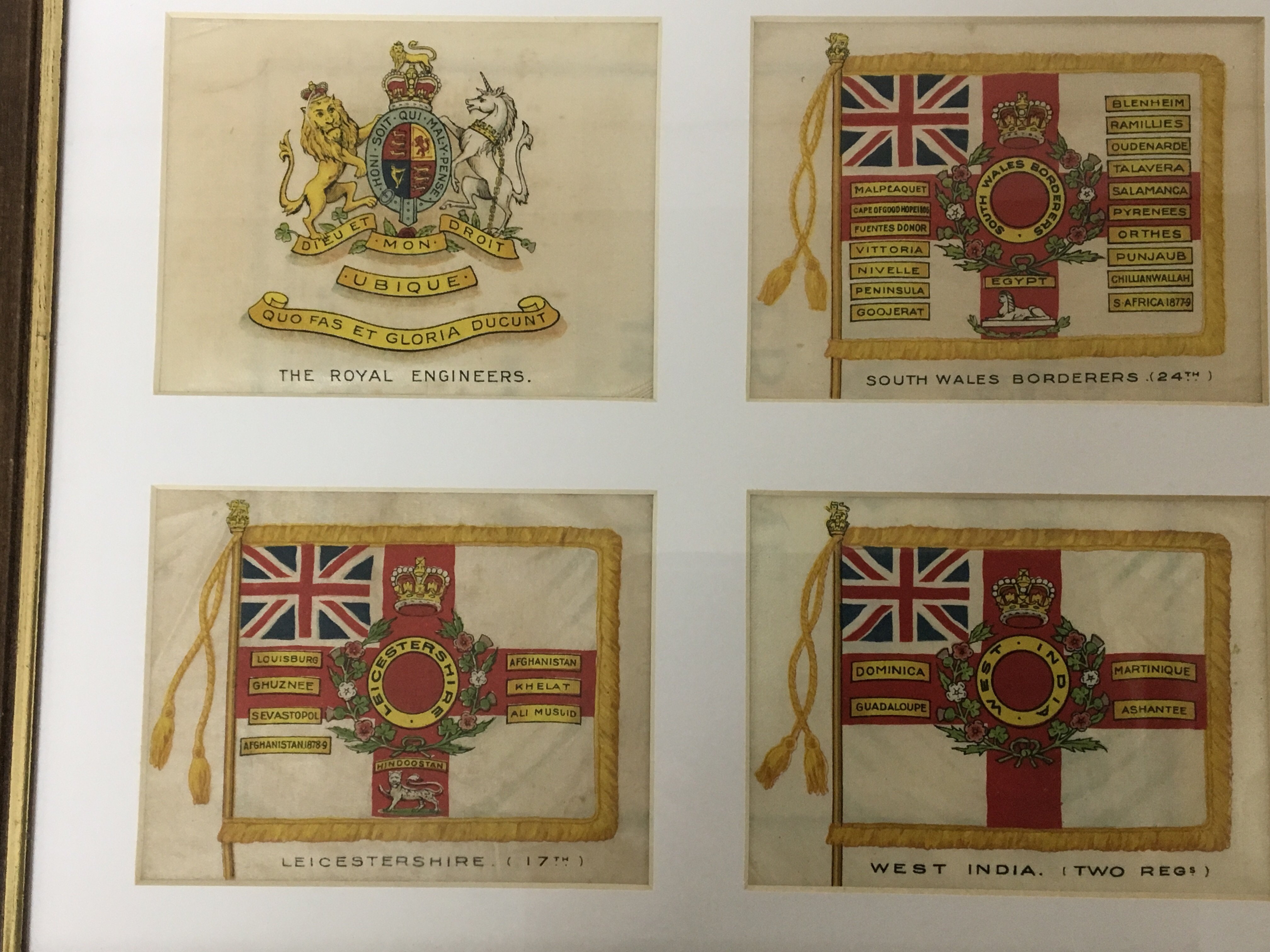 Four silks each with the flag or coat of arms of British Regiments. each flag 13x10cm.