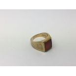 A 9ct gold Gents ring set with a polished stone, a