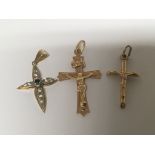 Three 9carat gold cross pendents one set with a bl