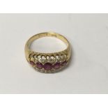 A 18 ct gold ring inset with five rubies size k