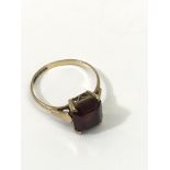 A 9ct gold ring set with a square cut garnet.Appro