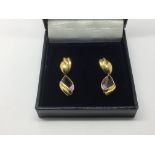 A pair of 18ct gold drop earrings set with pear sh