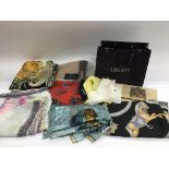 A collection of mixed designer scarves including B
