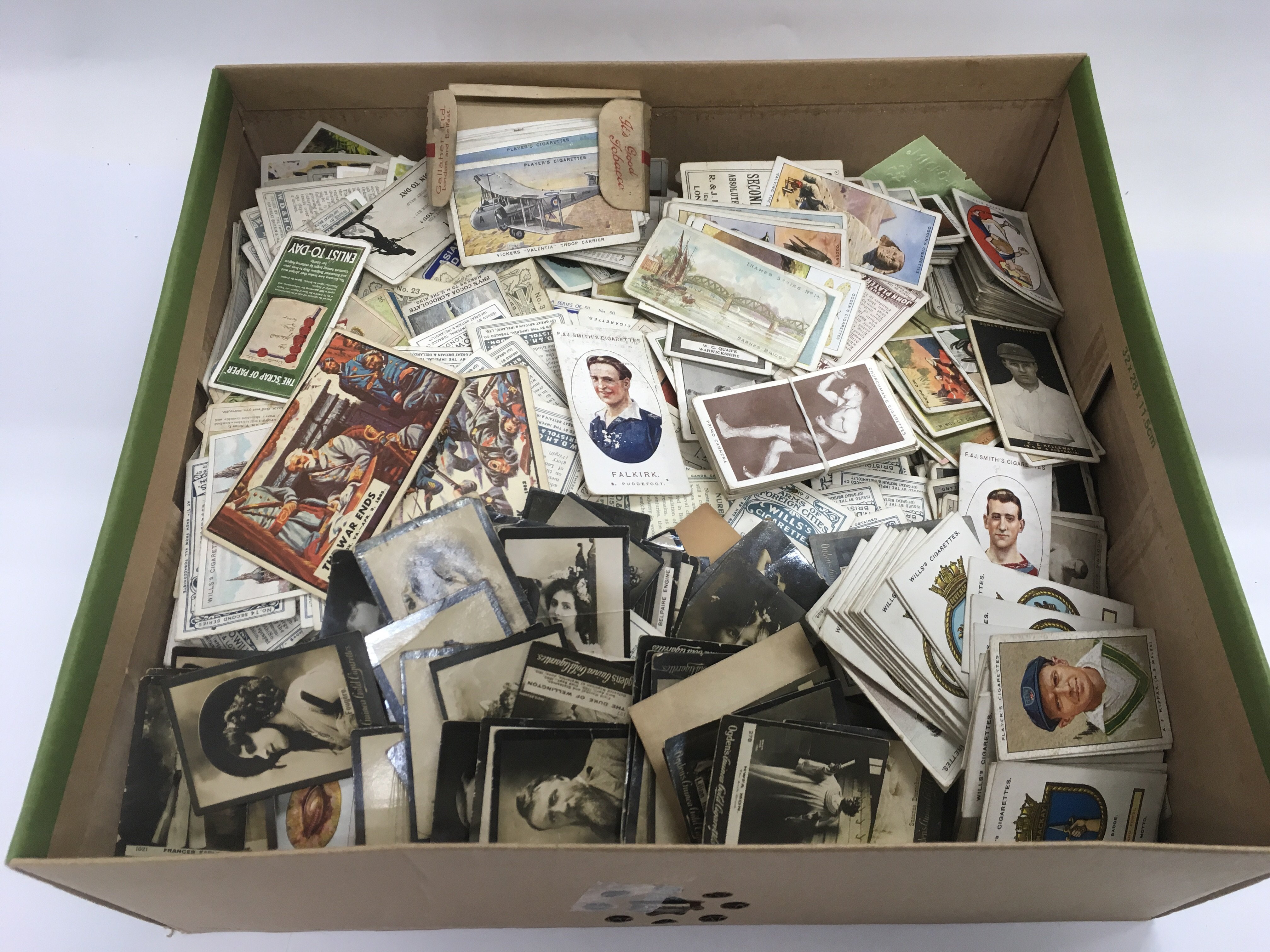 A box of loose cigarette cards.