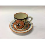 A Clarice Cliff coffee can and saucer decorated wi