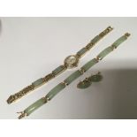 A 14carat gold mounted jade bracelet with matching