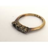 An 18ct gold ring set with small diamonds, lacking one stone